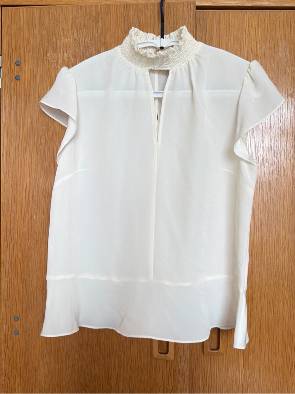 Cream Smocked High-Neck Flutter Sleeve Top
